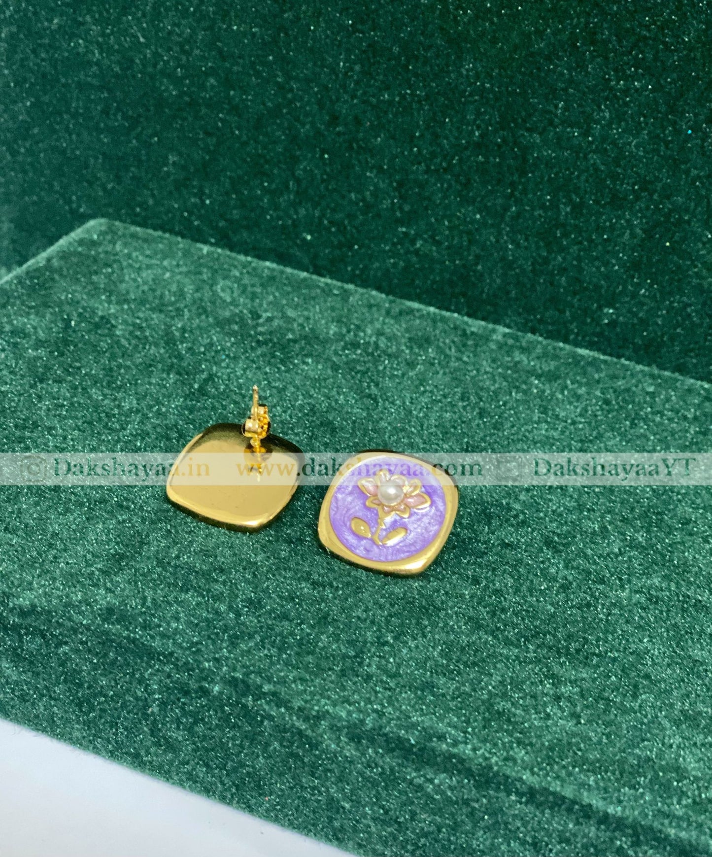 Gold and purple pendant on a green velvet background
