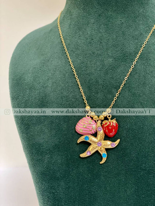 Necklace with starfish and shell pendant on a green mannequin