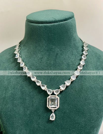 Necklace with a pendant on a green mannequin against a beige background