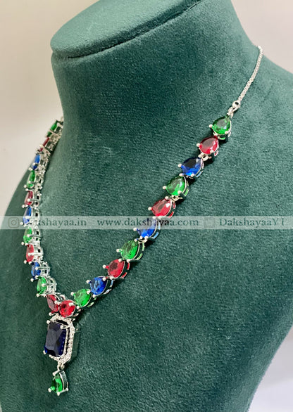 Multicolored gemstone necklace on a green mannequin