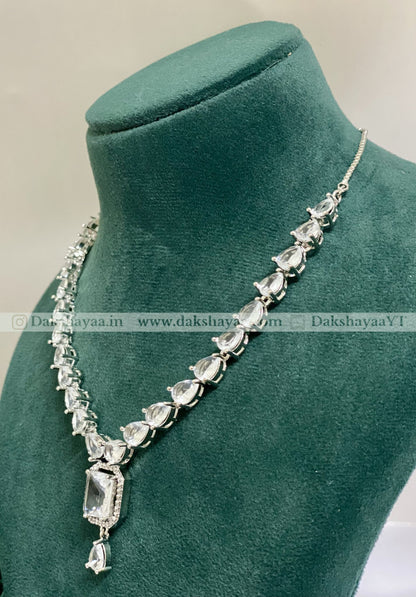 Silver necklace with clear stones on a green mannequin bust