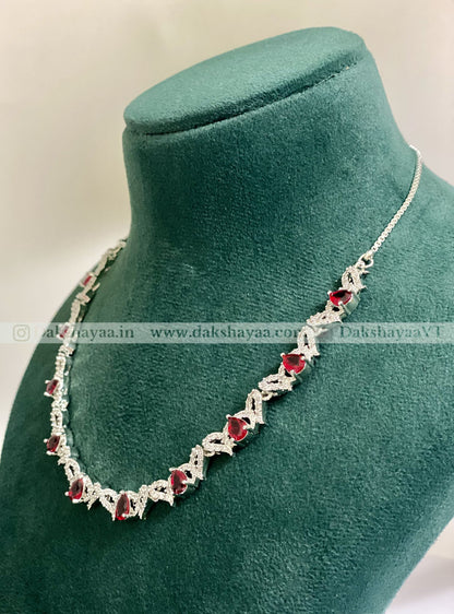 Necklace with red gemstones on a green mannequin