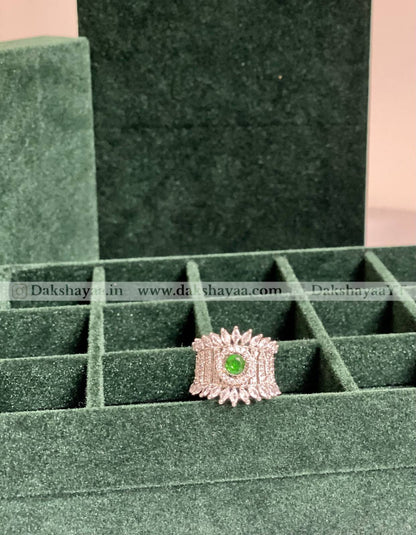 Ring with a green gemstone in a green jewelry box