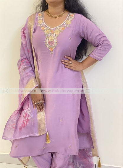Woman wearing a light purple embroidered kurta set cotton silk 