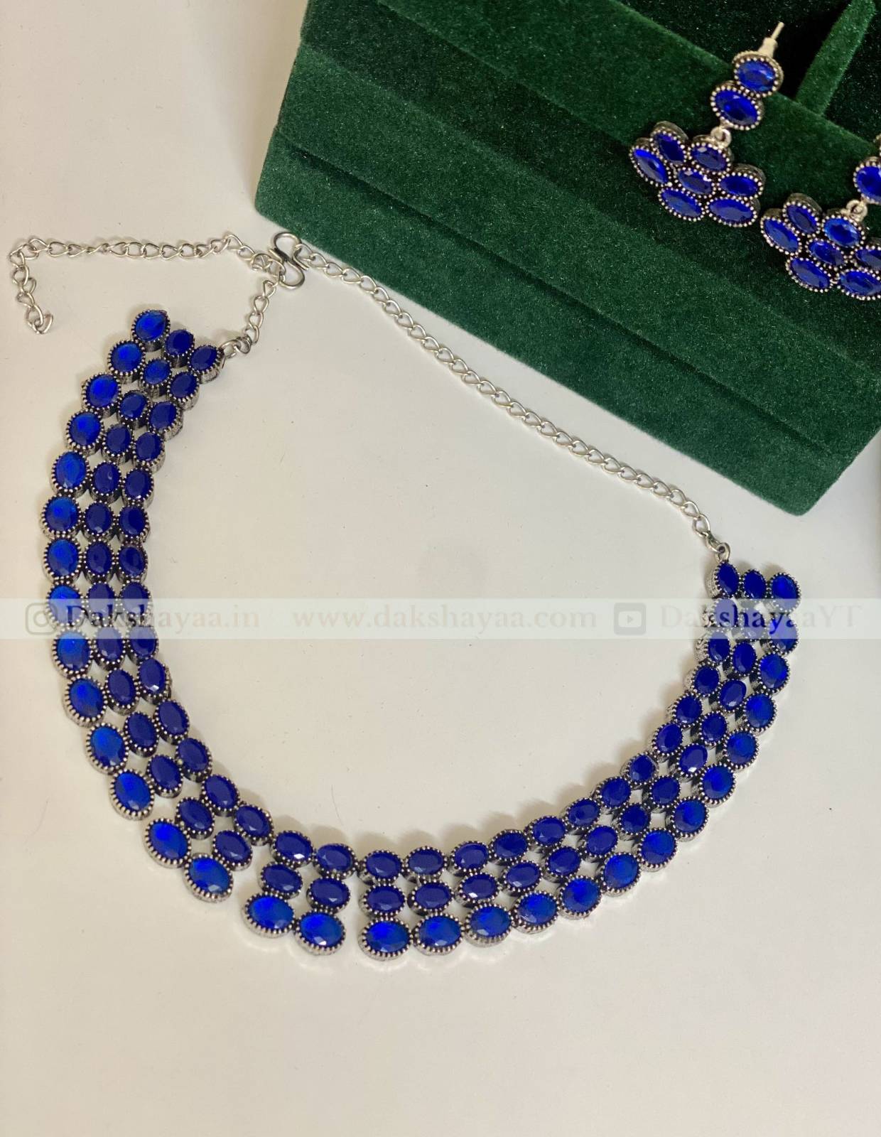 Blue necklace with silver chain on a white background