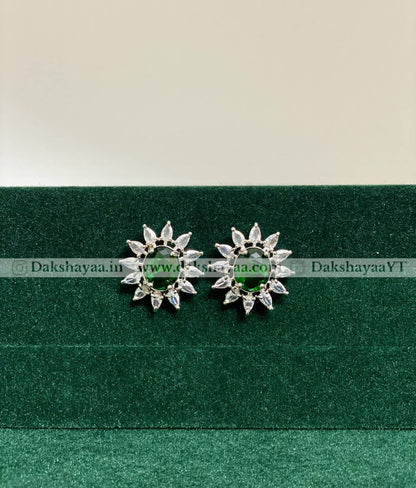 Pair of green silver earrings on a green background