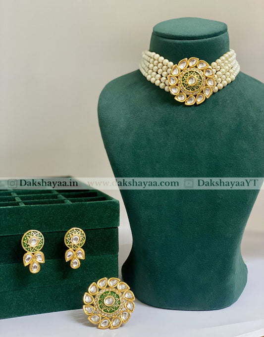 Jewelry set with necklace, earrings, and green box on a mannequin bust.