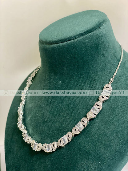Silver necklace on a green velvet mannequin bust