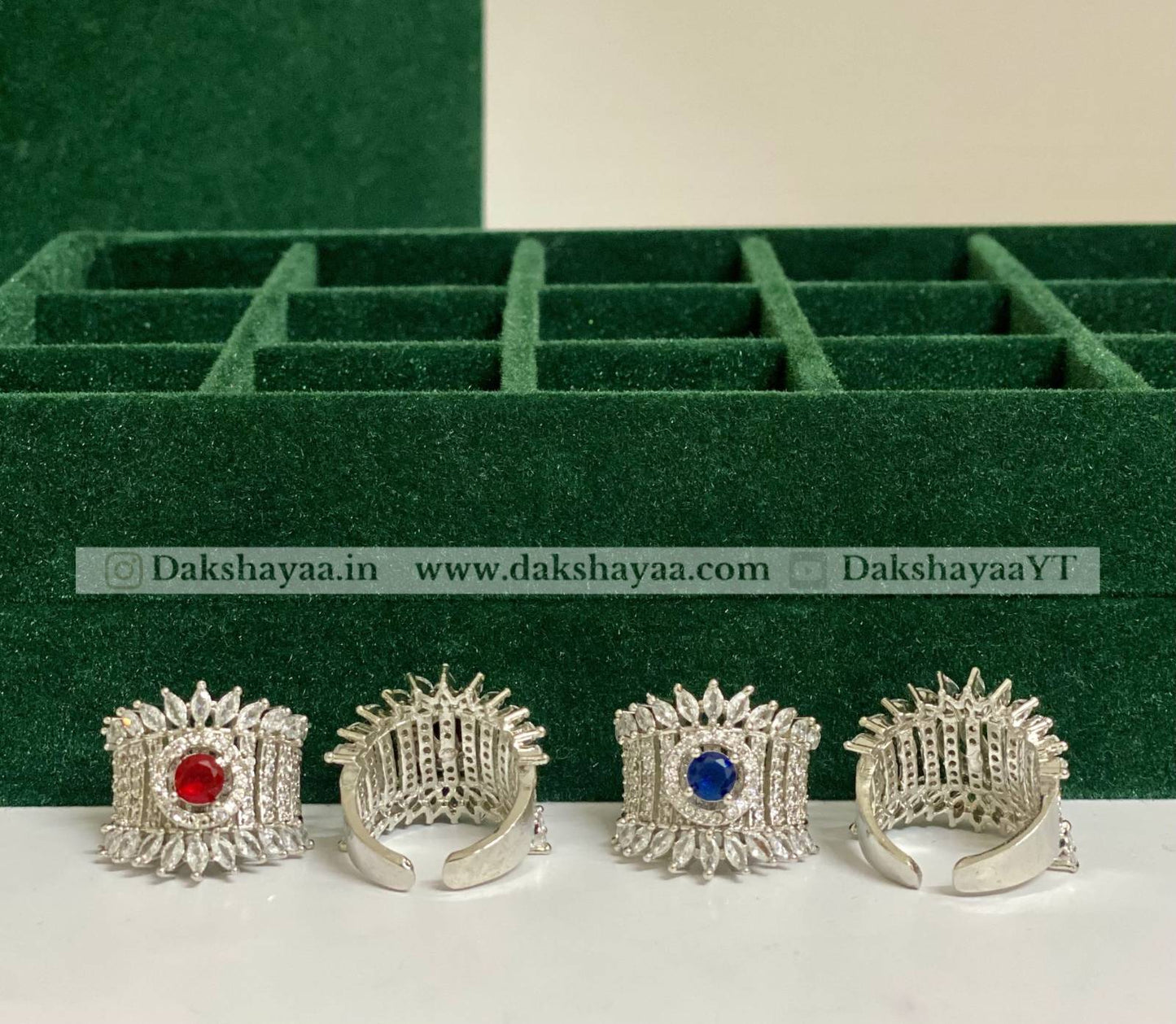 Silver rings with gemstones on a green jewelry box