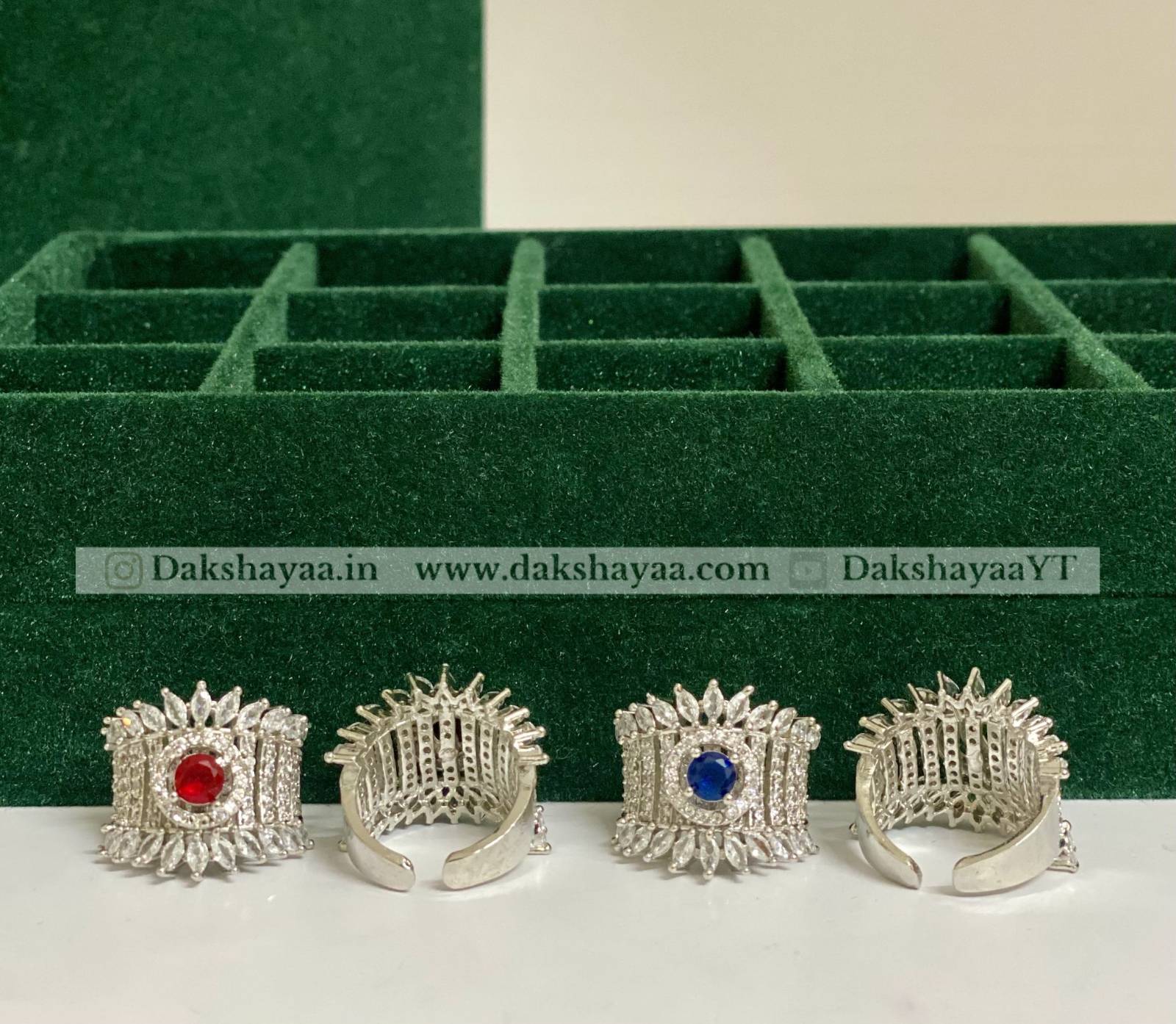 Silver rings with gemstones on a green jewelry box