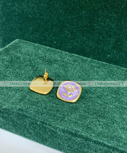 Gold and purple pendant on a green velvet background
