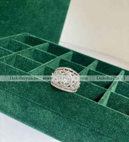 Silver ring with gemstones on a green velvet jewelry box